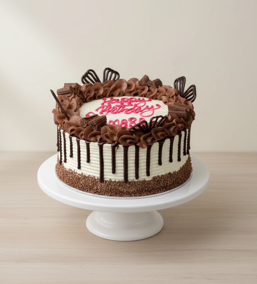 Chocolate birthday cake on white stand